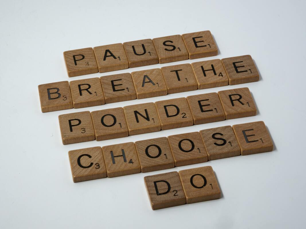 Scrabble letters spelling out: Pause. Breathe. Ponder. Choose. Do.