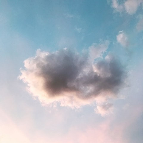 Blue sky with a pink cloud